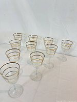 All ten wine glasses front view showing gold band decoration and stems