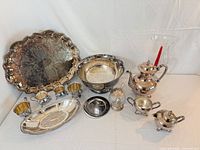 Full lot overview showing all silver-plated pieces, jars and vase