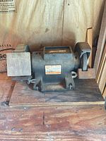 Front view of WEN bench grinder showing both wheels, tool rests and mounting base