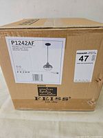 Closed shipping carton showing model P1242AF label and Feiss branding