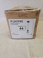 Sealed box showing model P1247PRZ label with specs