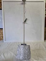 Assembled pendant light showing canopy, rod, wire lead, and cylindrical wire-wrapped shade with Feiss tag