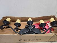 Front view of five-light wall sconce in box