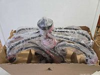 Chandelier frame wrapped in plastic inside original box