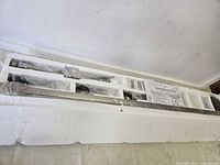 Foam insert holding rail, heads and hardware wrapped in plastic