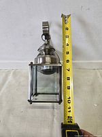 Lantern removed from box next to tape for scale showing roughly 12-inch height
