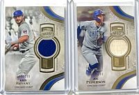 Both relic cards in cases side by side showing fronts and jersey swatches