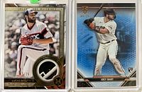 Both cards front view in sleeves showing players, relic patch and serial numbers