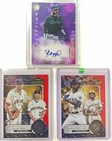 All three sleeved, top-loaded cards in team bags