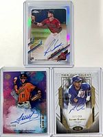 All three autographed baseball cards in top-loaders