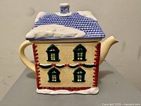 Front view of house-shaped ceramic teapot