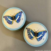 Two ceramic trinket boxes with butterfly lids