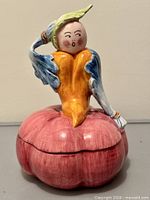 Front view of ceramic jar showing anthropomorphic design