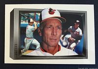 Front of 1989 Bowman Tiffany #260 card showing Cal Ripken Sr. portrait with Cal Ripken Jr. and Billy Ripken action images