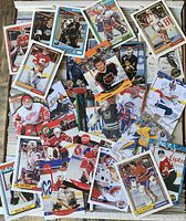 Top view of assorted goalie hockey cards spread over box