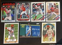 Front view of seven Jo Adell rookie baseball cards in sleeves