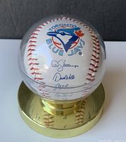 Front view showing Blue Jays logo, signatures, holder and base