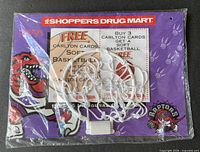 Front of sealed package showing Raptors calendar and mini hoop