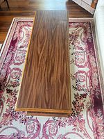 Top surface of rectangular coffee table showing walnut grain laminate