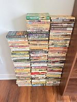 Three stacks of Western paperbacks showing spines, approx 150 books