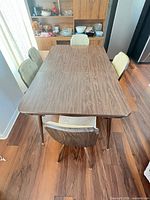 Top view of dining table with five chairs around it