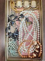 Top view of all jewelry pieces in box showing variety