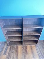 Front view of both bookcases showing shelves and finish