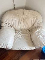 Front view leather armchair showing cushion wrinkling
