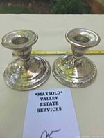 Front view of both La Pierre sterling candlesticks
