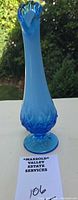 Full front view of blue opalescent Fenton bud vase