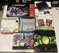 Group shot of all eight game console and game boxes
