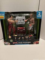 Front of sealed box showing fighters, controllers, branding and features