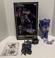 Group shot of Shockwave with box, accessories bag and three Sharkticons