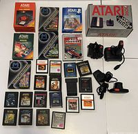 Full lot showing console box, controllers, power adapter, RF switch, game boxes and loose cartridges