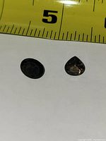 Two faceted smoky topaz stones with tape measure for scale