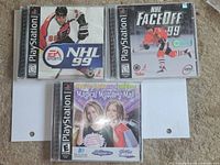 Front view of three PS1 games in jewel cases