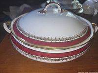 Side view of covered vegetable bowl showing maroon band and gold trim
