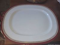 Top view of oval platter showing burgundy and gold rim