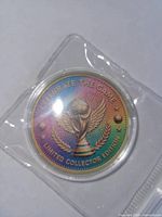 Obverse of enameled medallion in capsule, text Celebrate The Game Limited Collector Edition