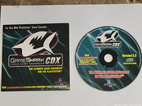 Front view of GameShark CDX disc and sleeve