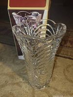 Front view of crystal vase next to box