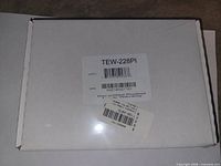 Front of sealed white retail box with product label TEW-228PI visible