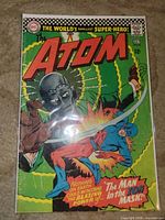 Front cover of The Atom #25 in bag and board