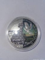 Obverse showing soldier, dove, War Peace text