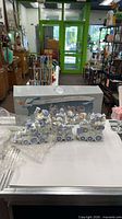 Three-piece resin train set with box displayed on counter