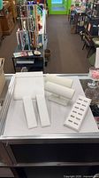All six jewelry display fixtures grouped on counter