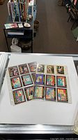 Two binder sleeves filled with Topps trading cards on display counter
