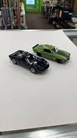 Both 1/32 scale model cars side by side