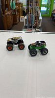 Both monster trucks side by side