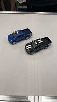 Both Ford Raptor model trucks side by side